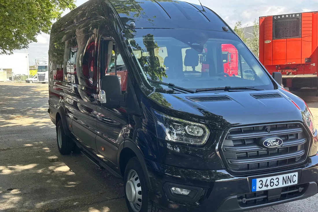 Black Ford Transit minibus, front view