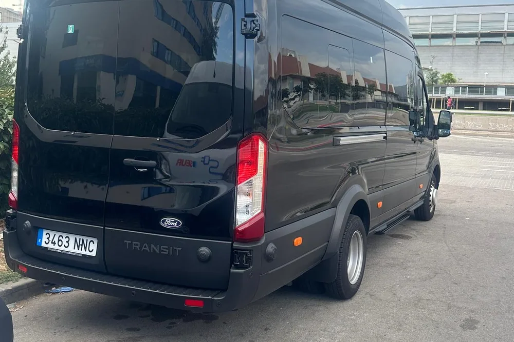Black Ford Transit minibus, rear view