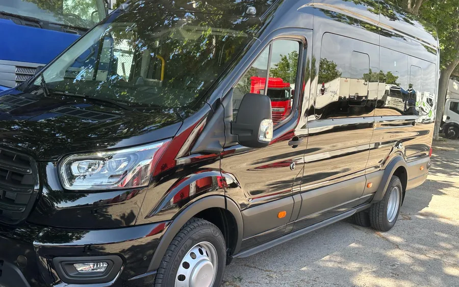 Black Ford Transit minibus